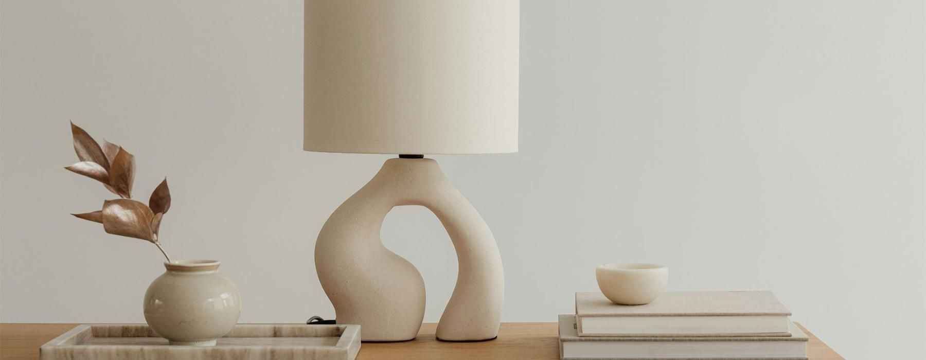 a lamp, stack of books, and decor