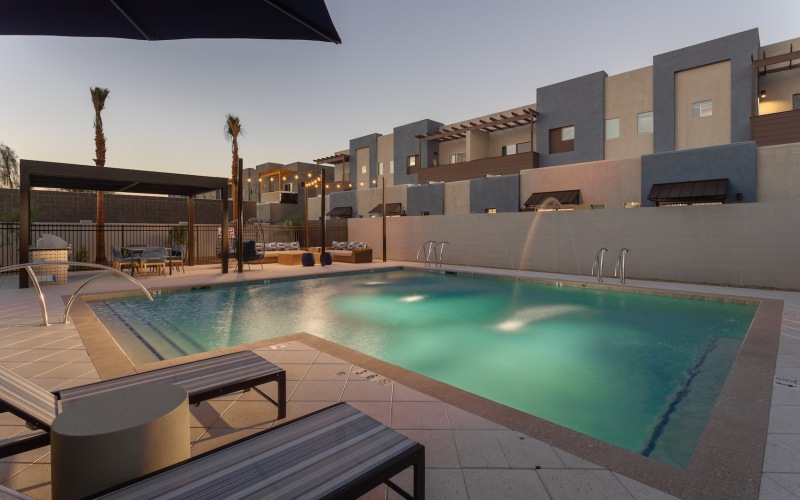 Resort-style swimming pool with lounge seating