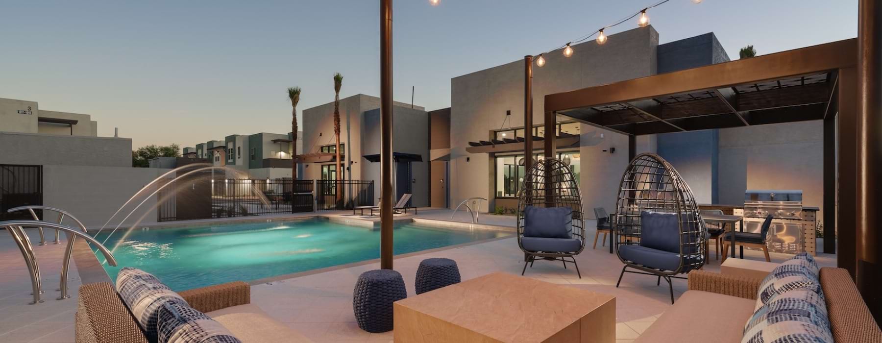 Resort-style swimming pool with lounge seating